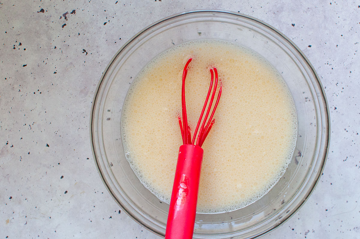 Whisking wet ingredients in a bowl