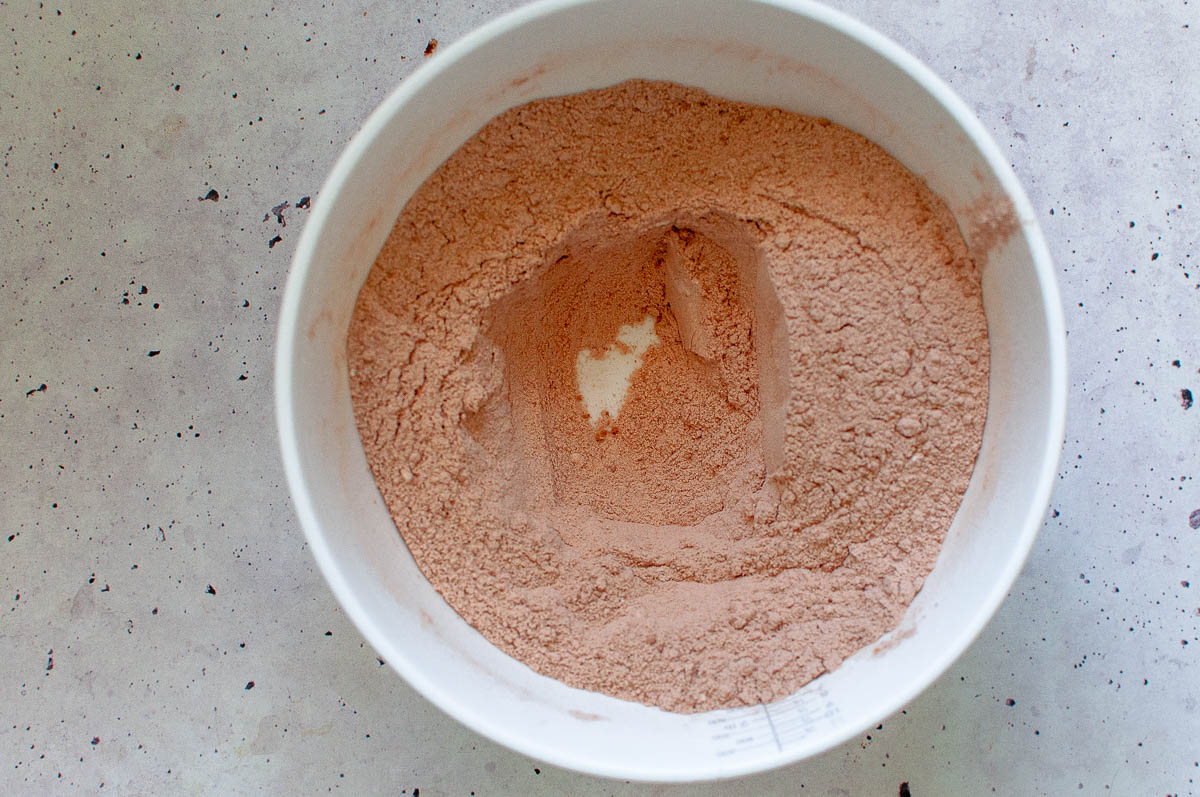 Making a well in the centre of the dry ingredients