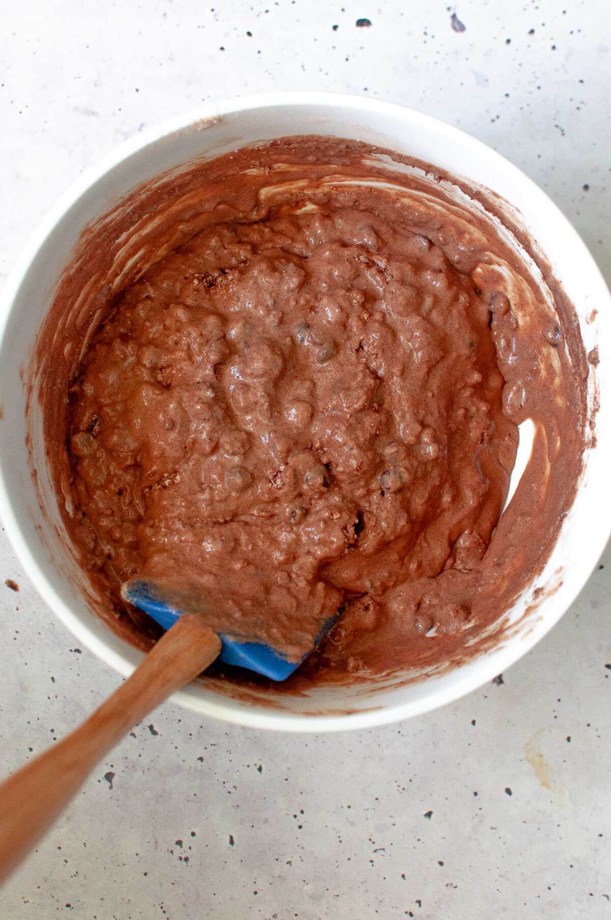 a bowl of chocolate muffin batter mixed together