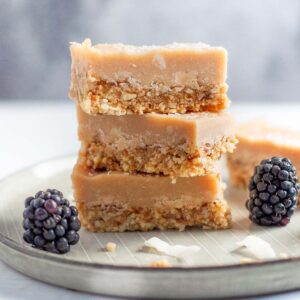 3 ginger slices on a plate with blackberries