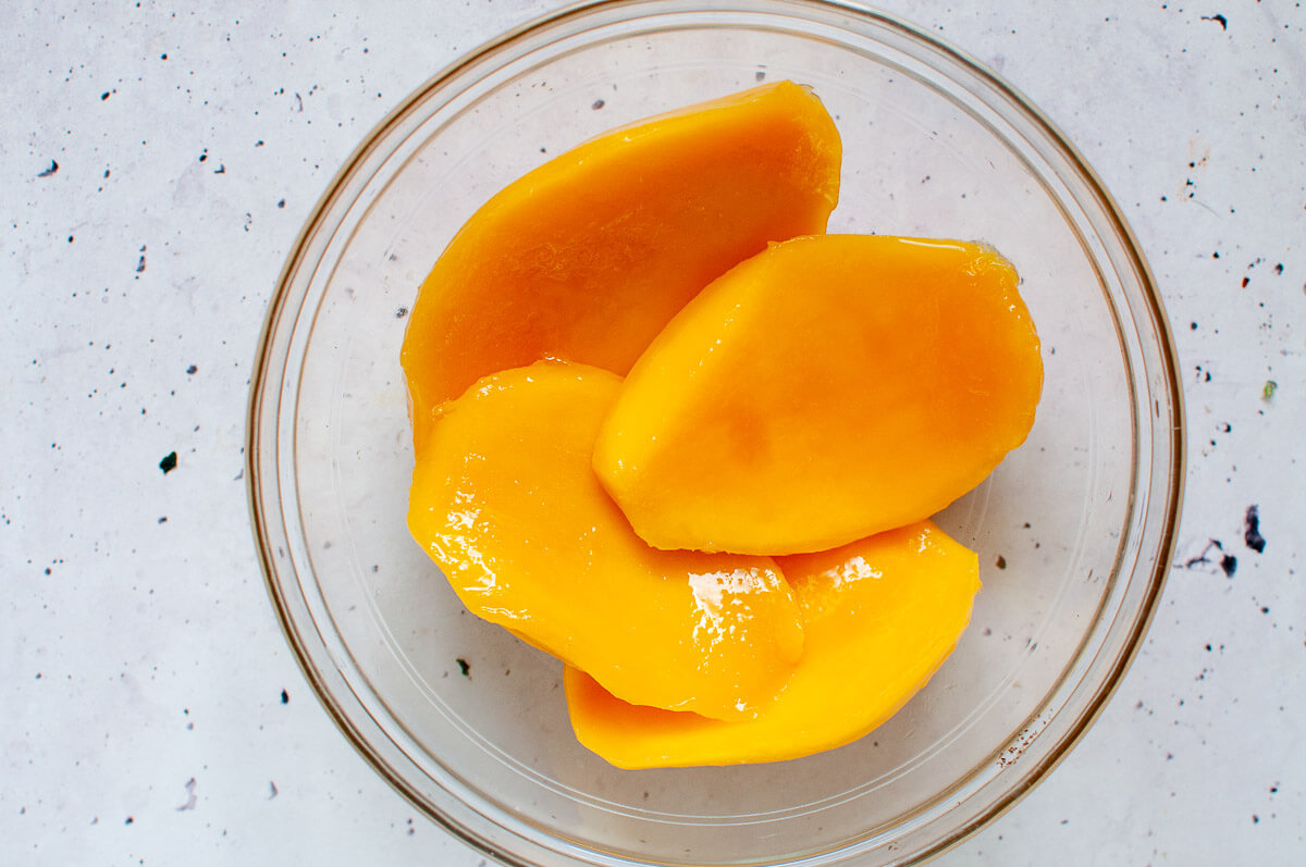 4 mango cheeks in a glass bowl