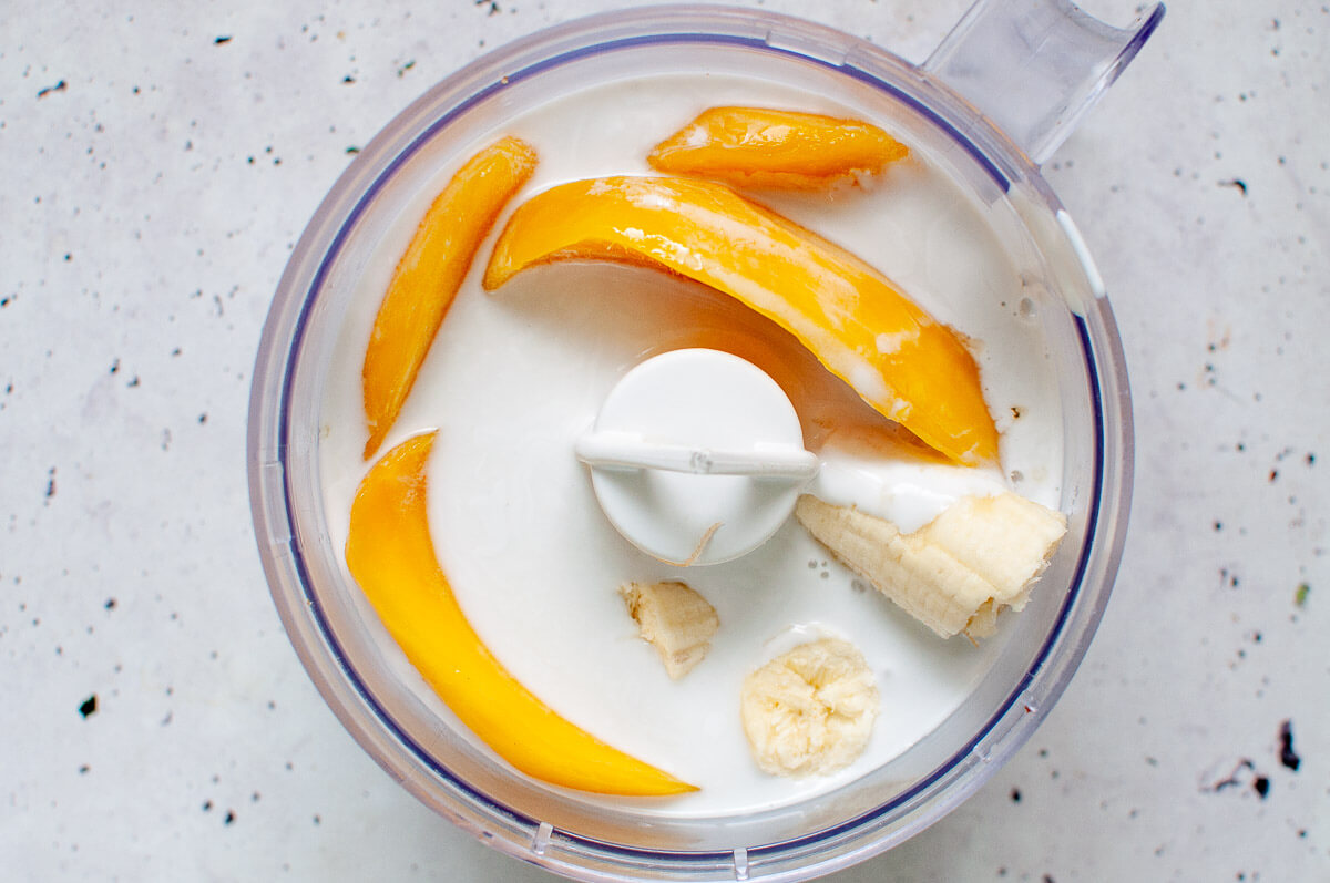 mango, banana, coconut milk and honey in a food processor before blitzing