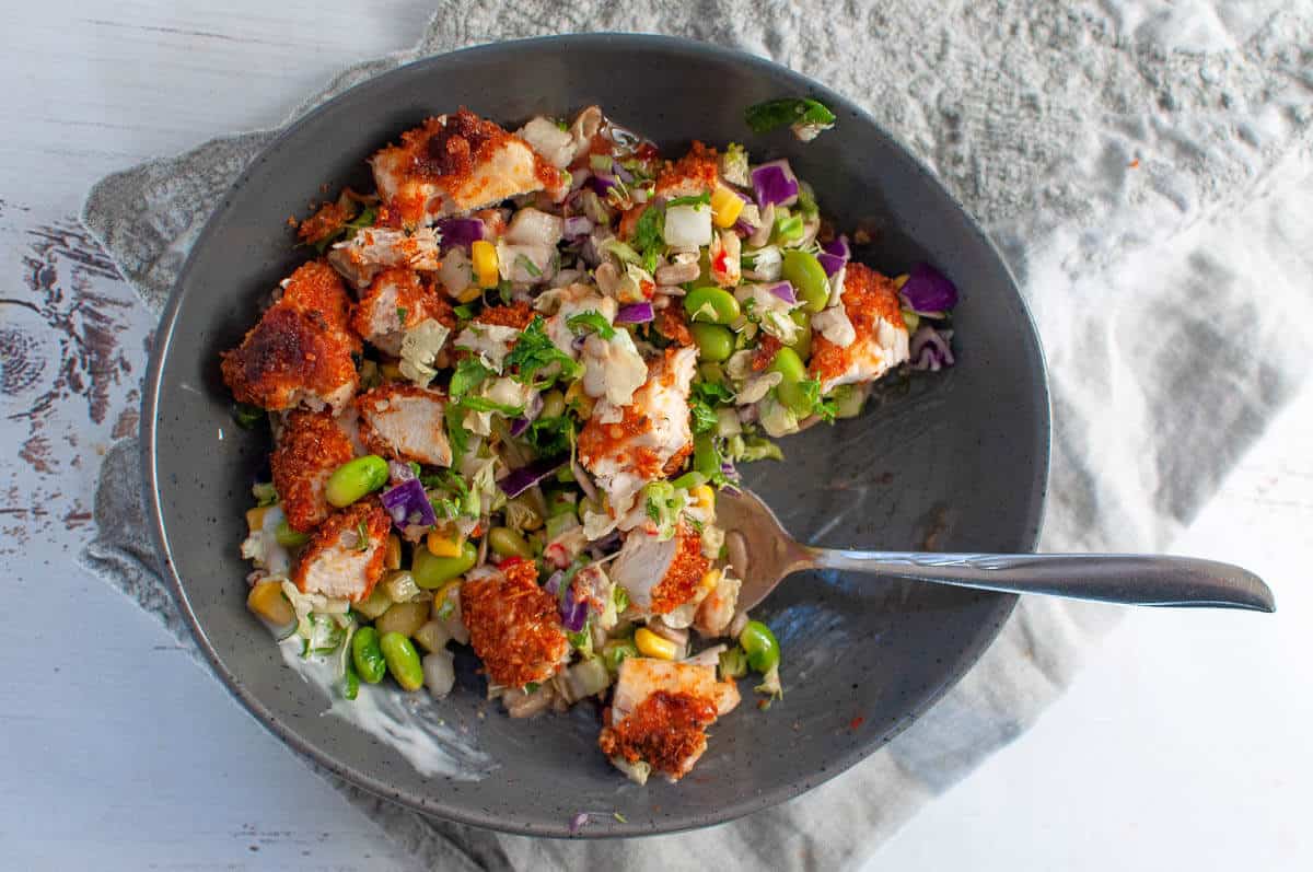 paprika parmesan chicken chopped up in a salad bowl