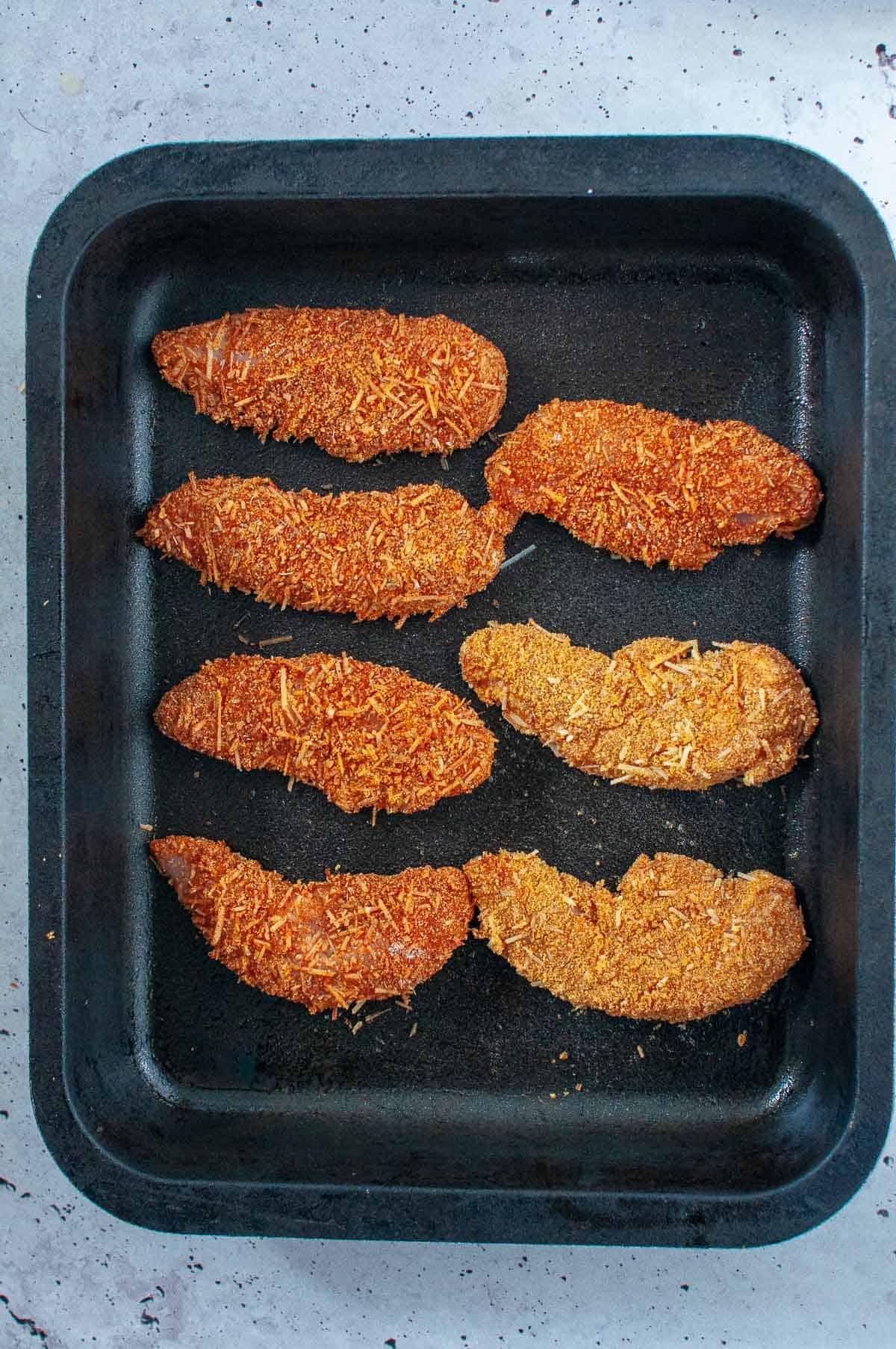 chicken tenders in a baking tray ready for oven