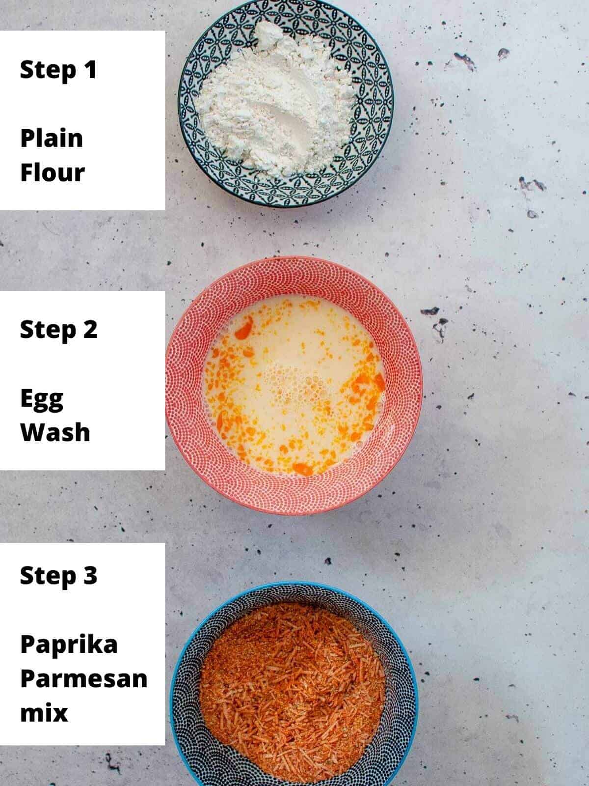 three bowls lined up for flour, egg wash and crumb mix