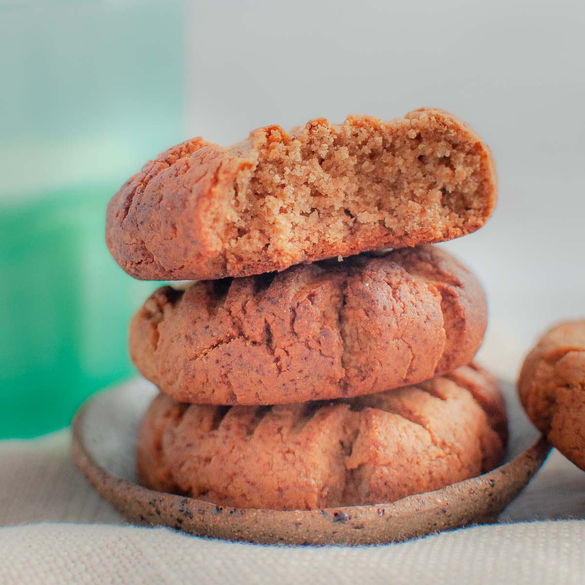 a stack of 3 cookies with a bite out