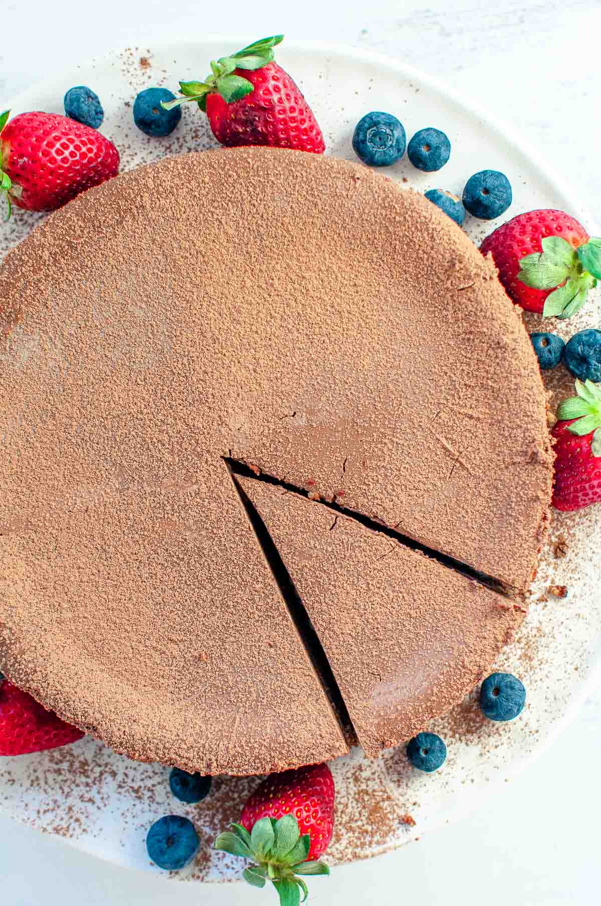 chocolate cheesecake and berries on a serving platter