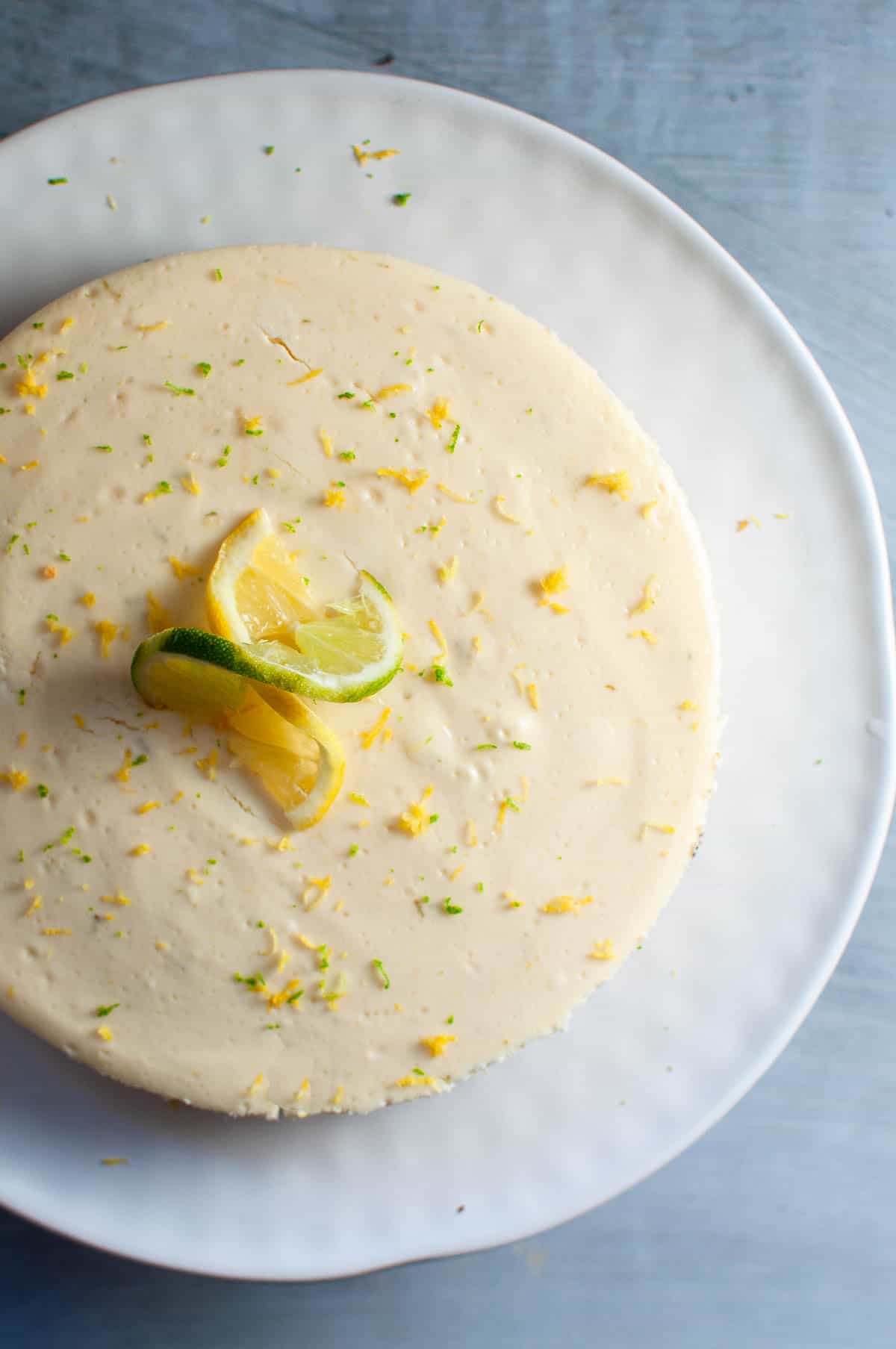 Lemon and Lime cheesecake on a serving platter, unsliced