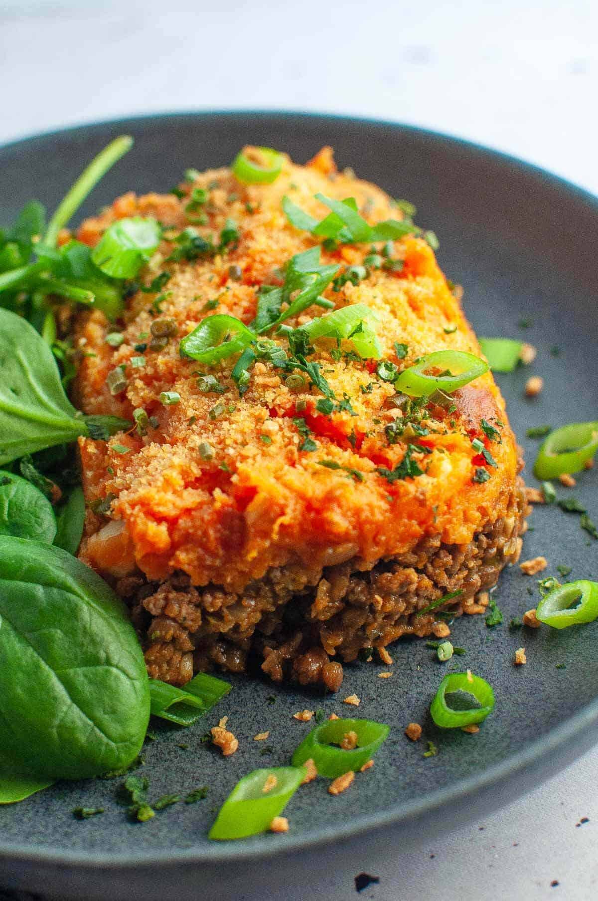 a slice of beef shepherds pie with masked sweet potato on a plate