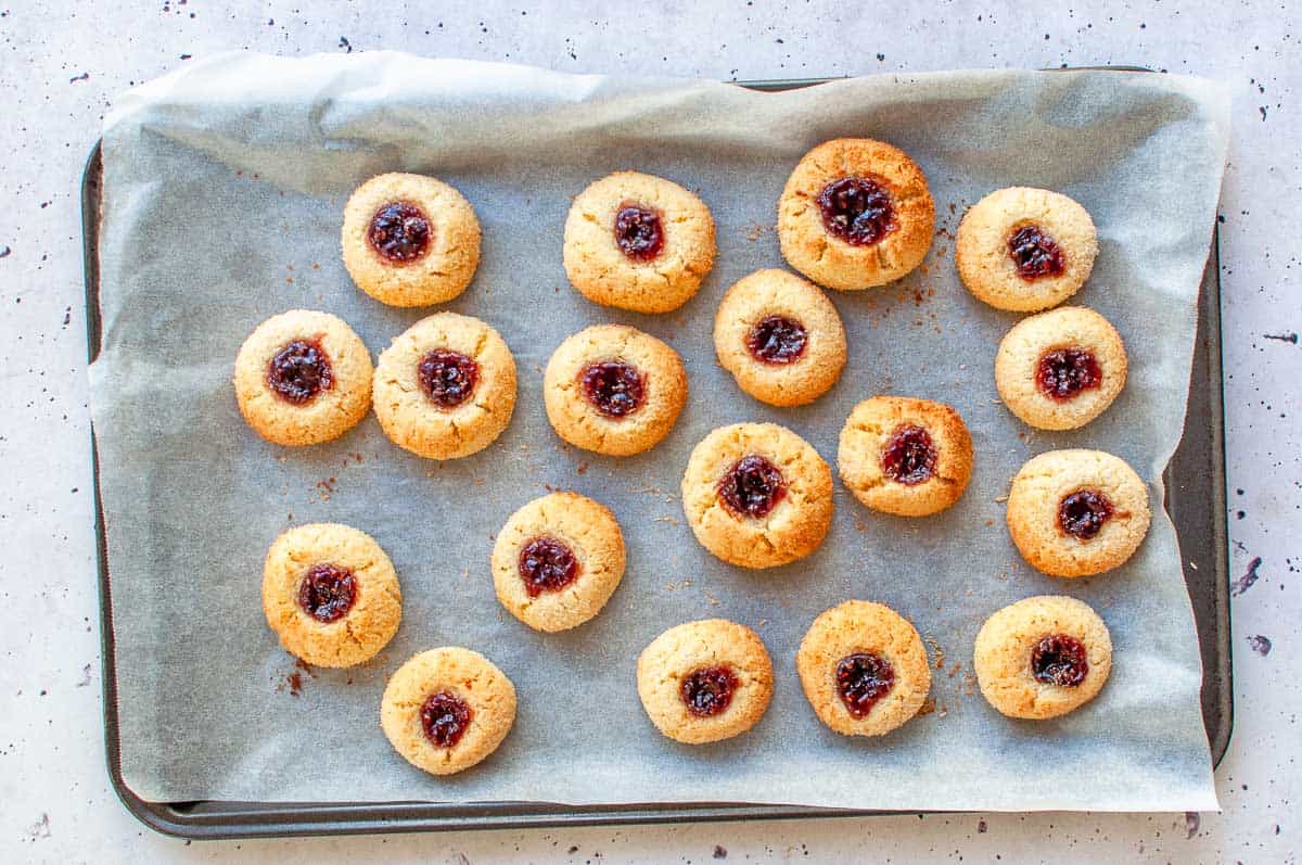 a large baking tray with cooked jam drop from the oven