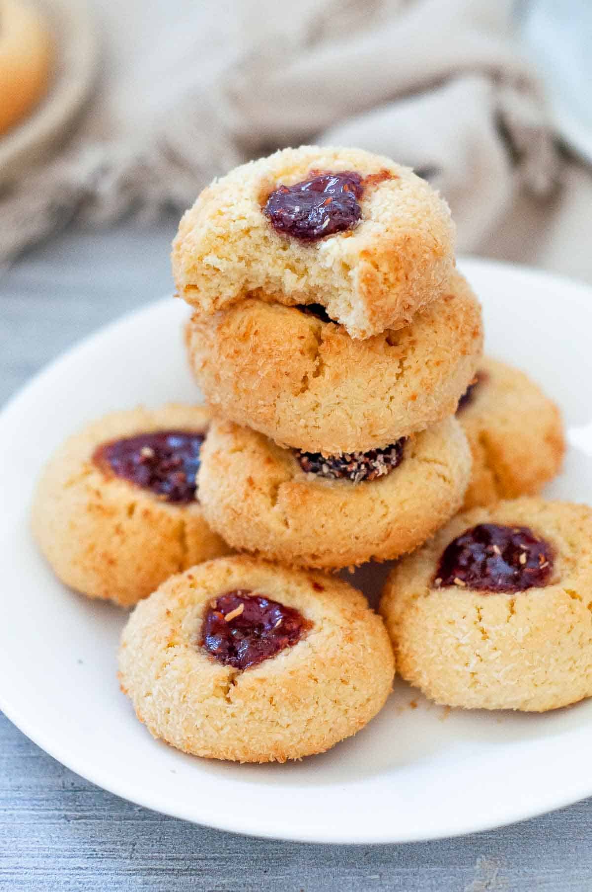 a stack of 6 coconut jam drops, one with a bite out