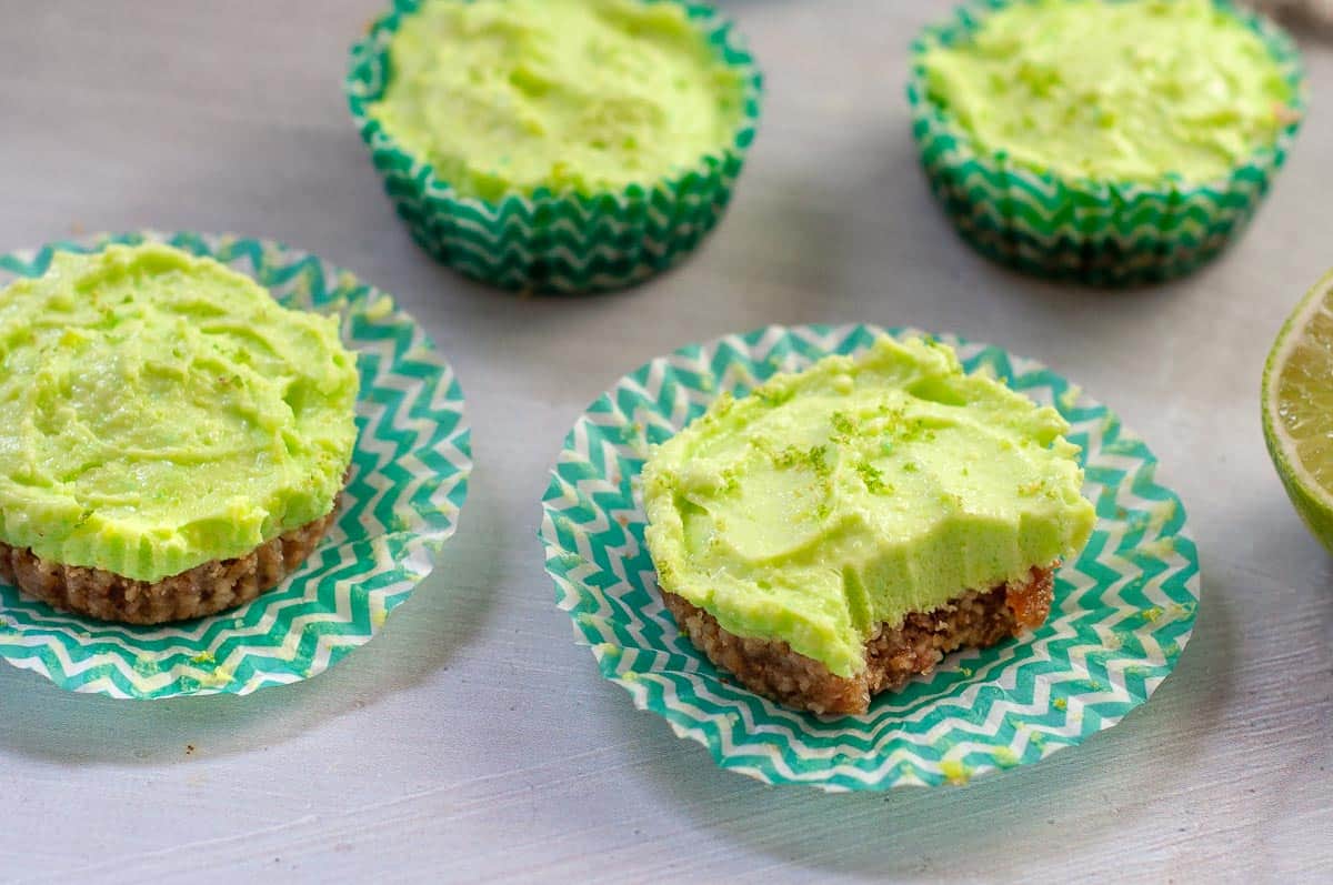 four mini lime cheesecakes on a bench