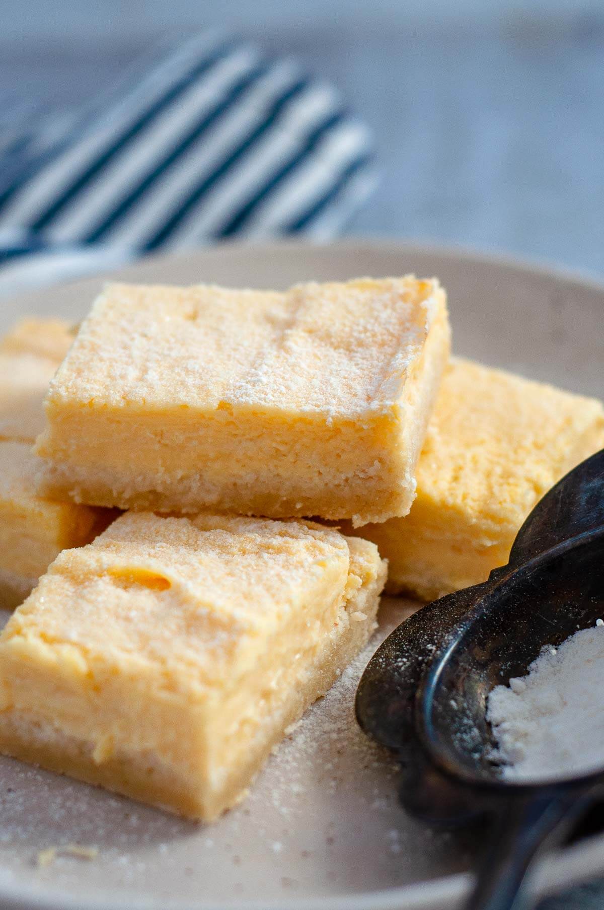 a stack of lemon bars on a serving plate