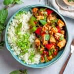 blue bowl with white rice and thai chili chicken stir fry