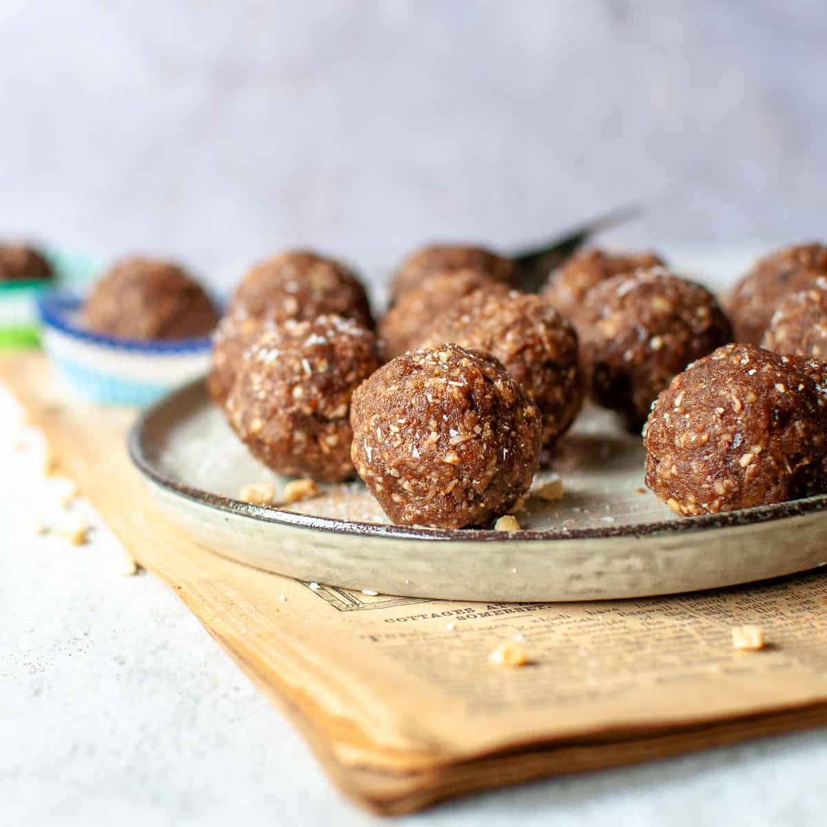 bliss balls on a plate with extra peanuts