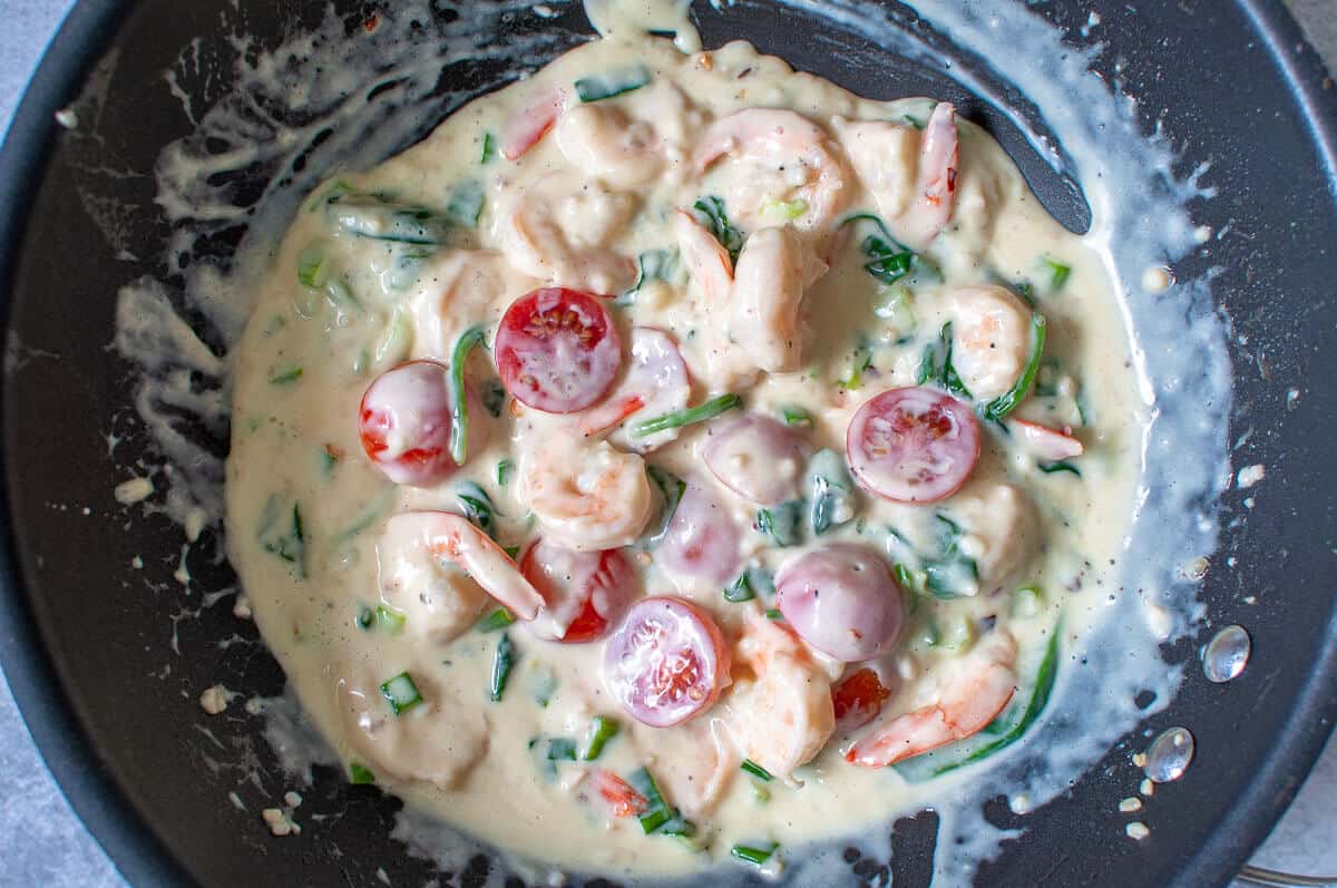 creamy garlic prawns cooking in a pan