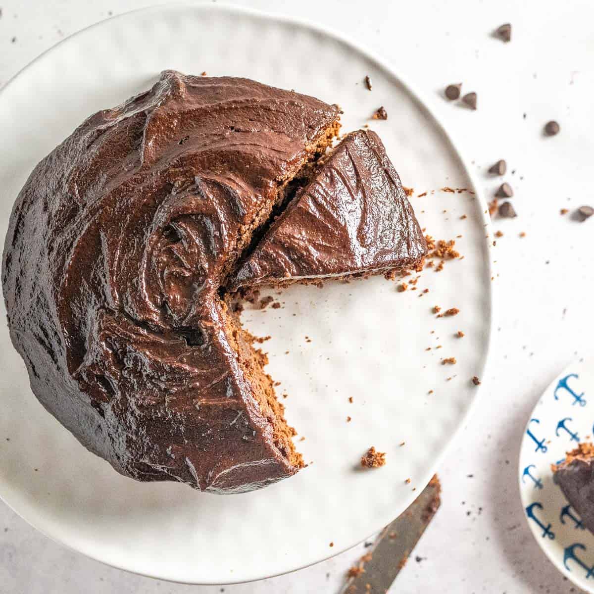 chocolate cake on a serving plate with slices taken out