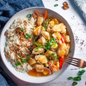 sweet and sour fish with rice in a bowl