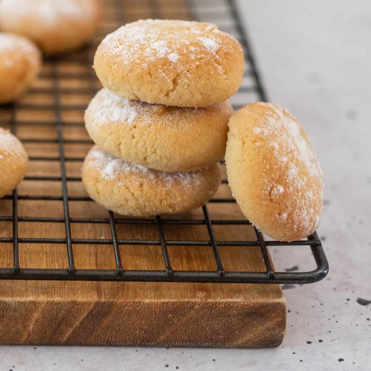 four amaretti biscuits stacked on a wire rack