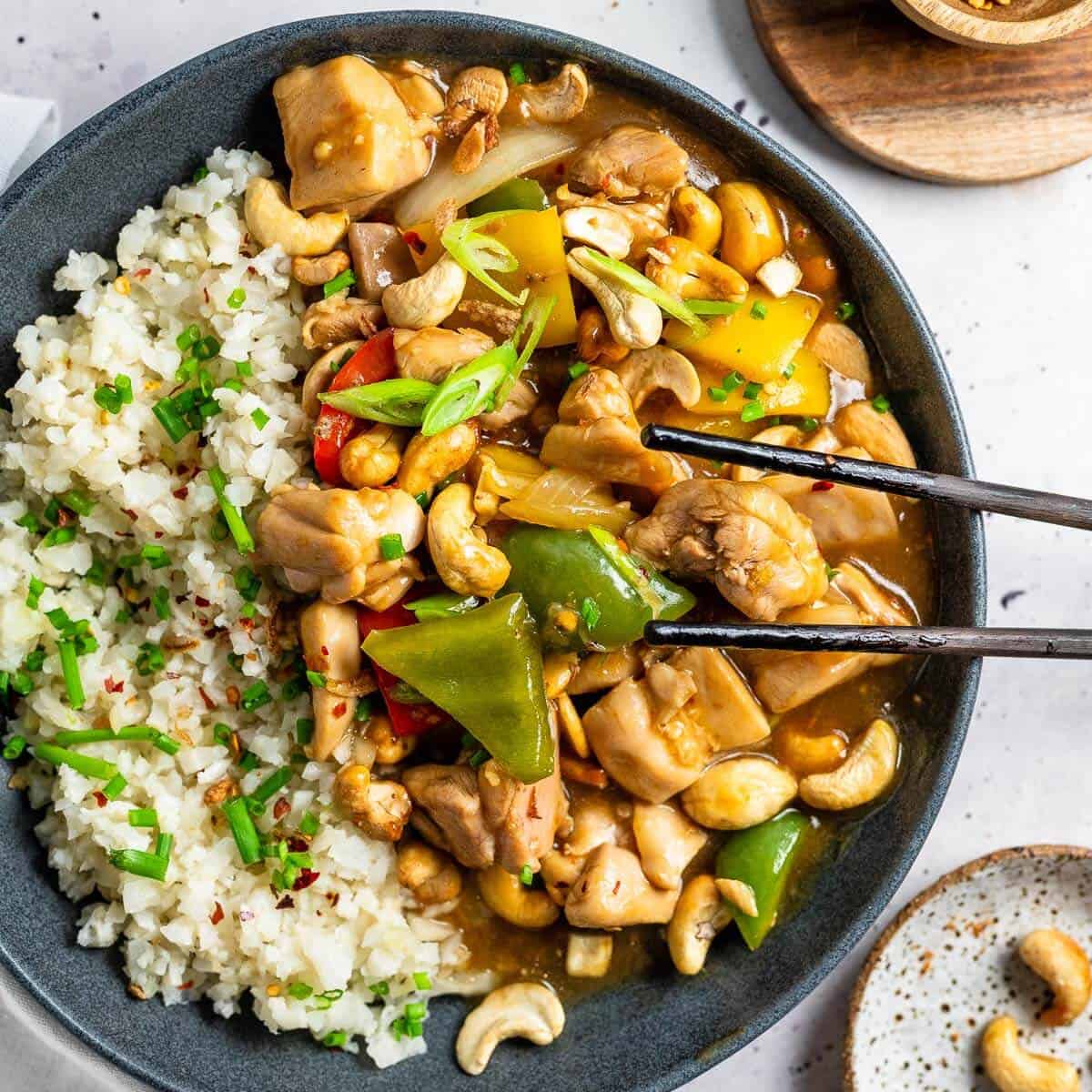 a bowl of cashew nut chicken with rice