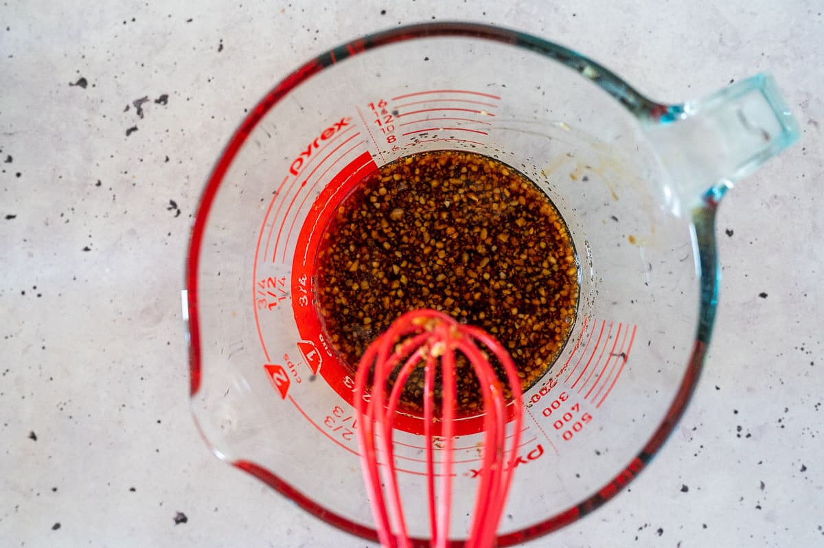 whisking sauce ingredients in a jug