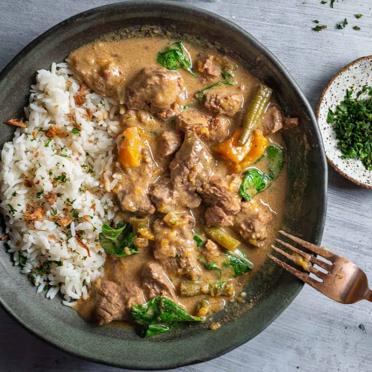 A bowl green thai beef curry slow cooker