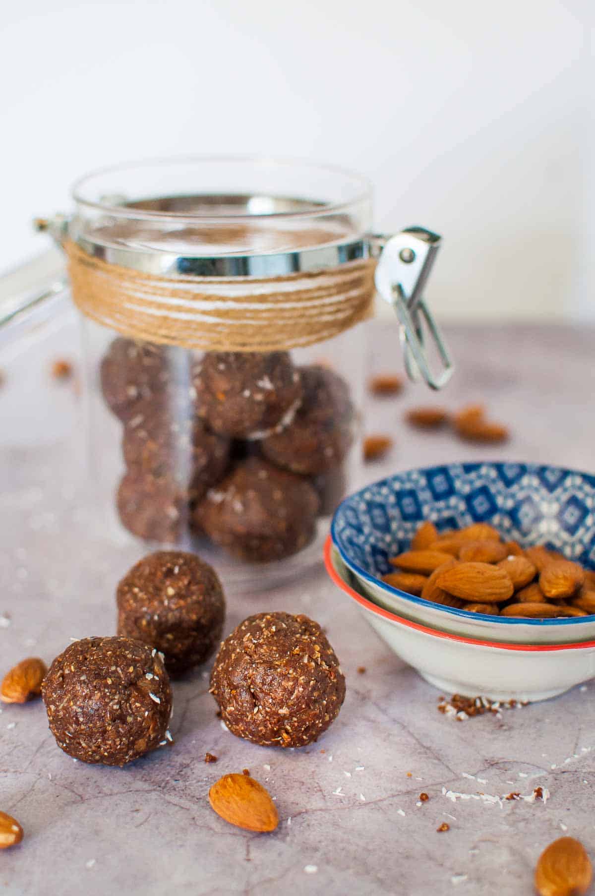 3 almond butter bliss balls on a bench