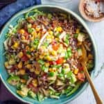 healthy ground beef burrito bowl with toppings in a blue bowl