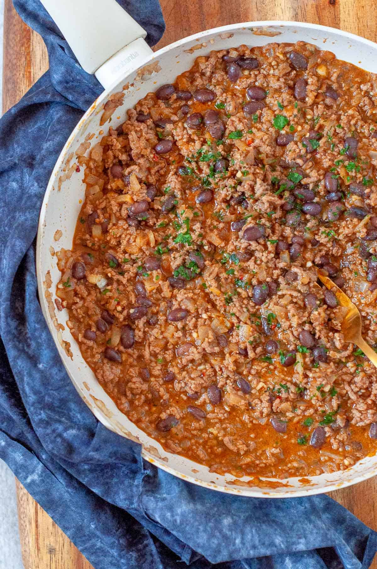 a pan with cooked beef and black beans