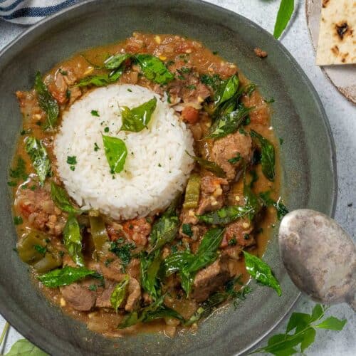 kerala beef curry with rice in a dark grey bowl