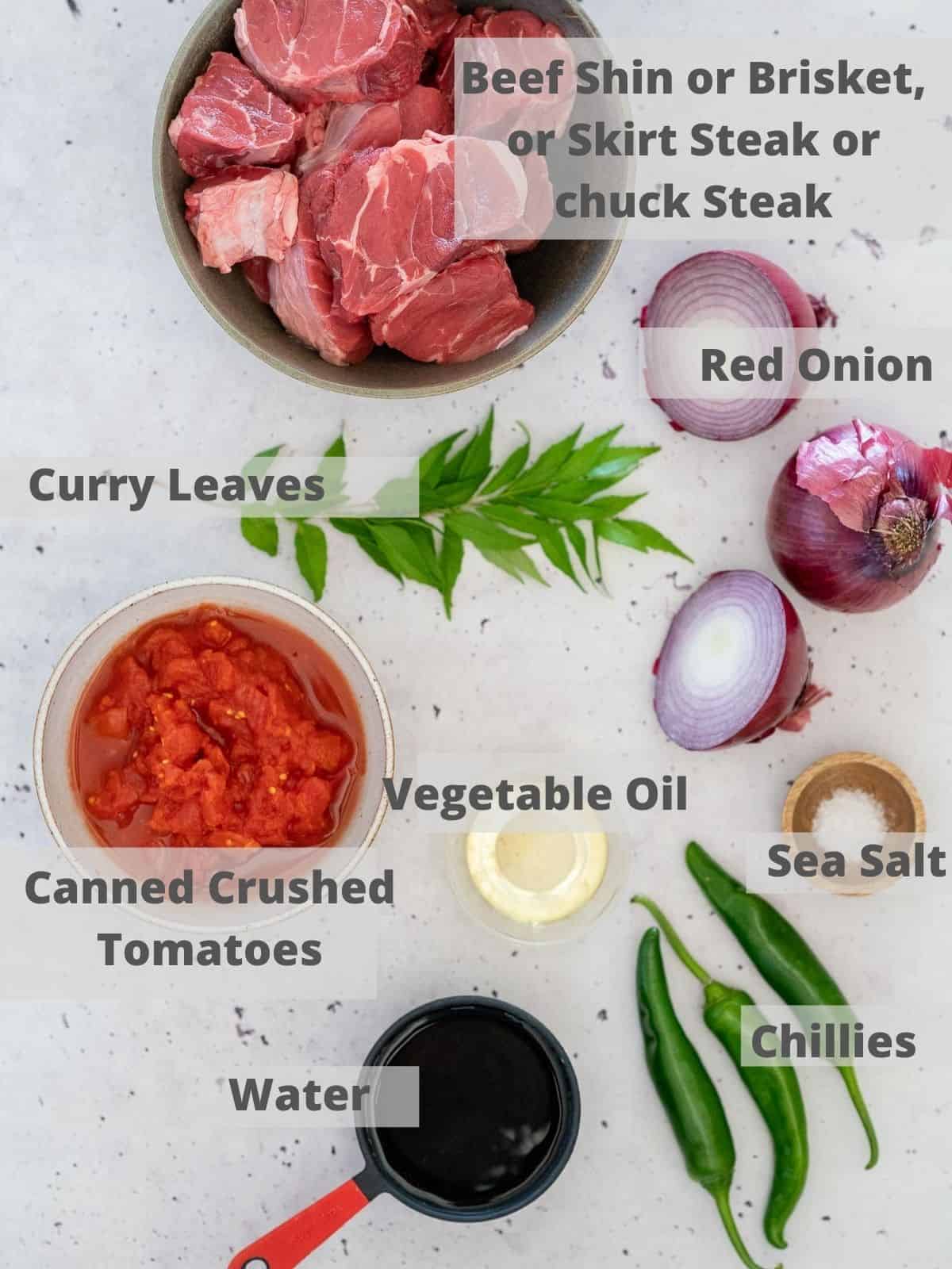 kerala beef curry ingredients on a bench