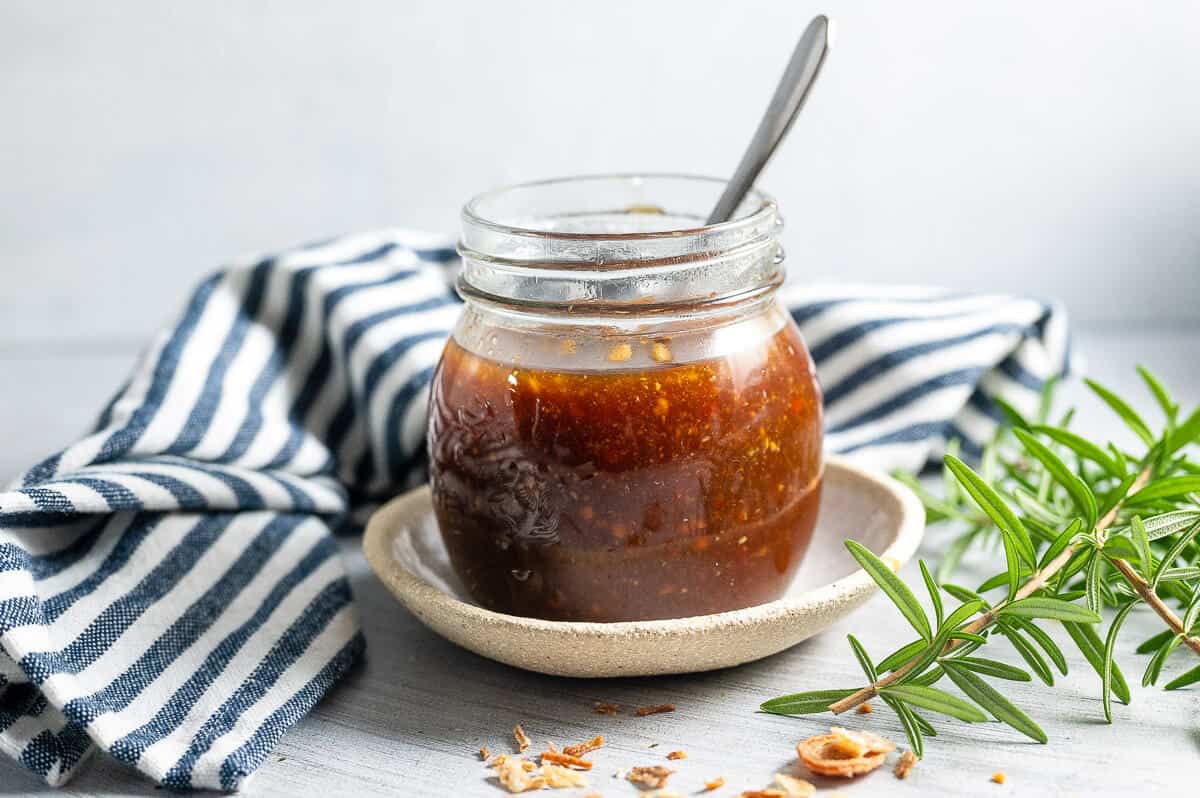 a jar of healthy asian sauce with a spoon in