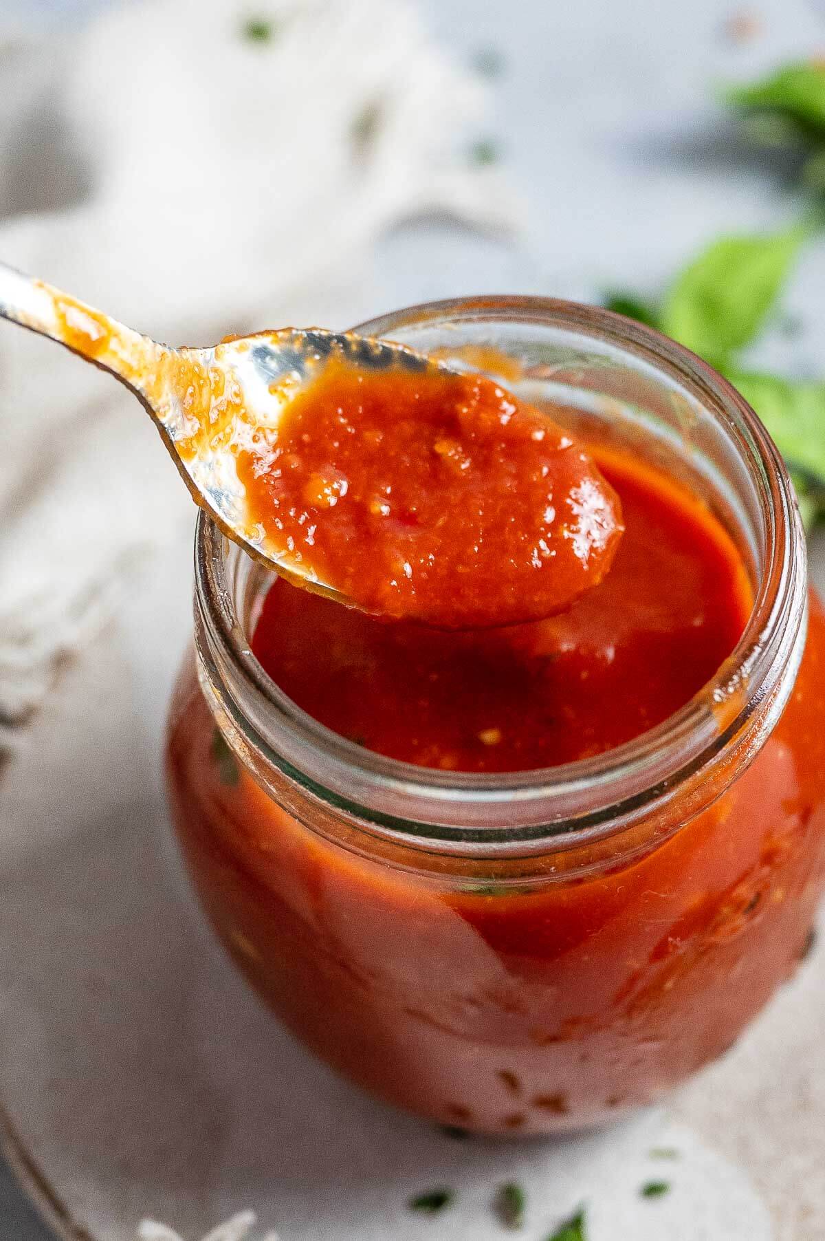 a spoonful of sweet and sour sauce from a jar