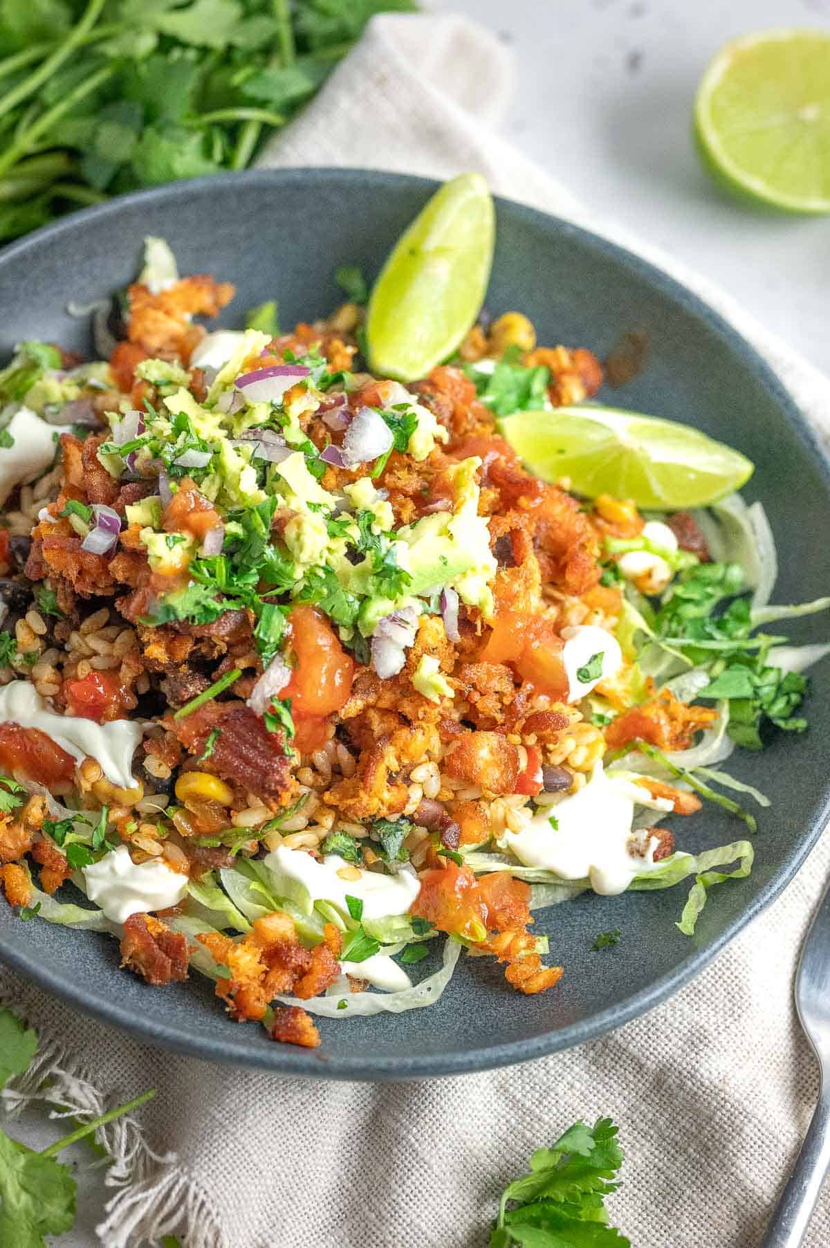 salmon burrito bowl with lime wedges