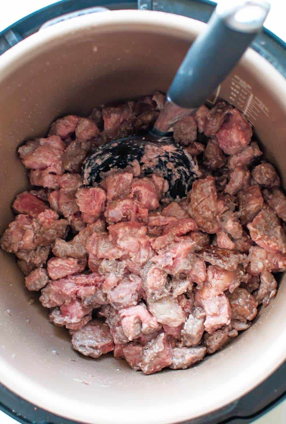 browning beef chunks in slow cooker pot