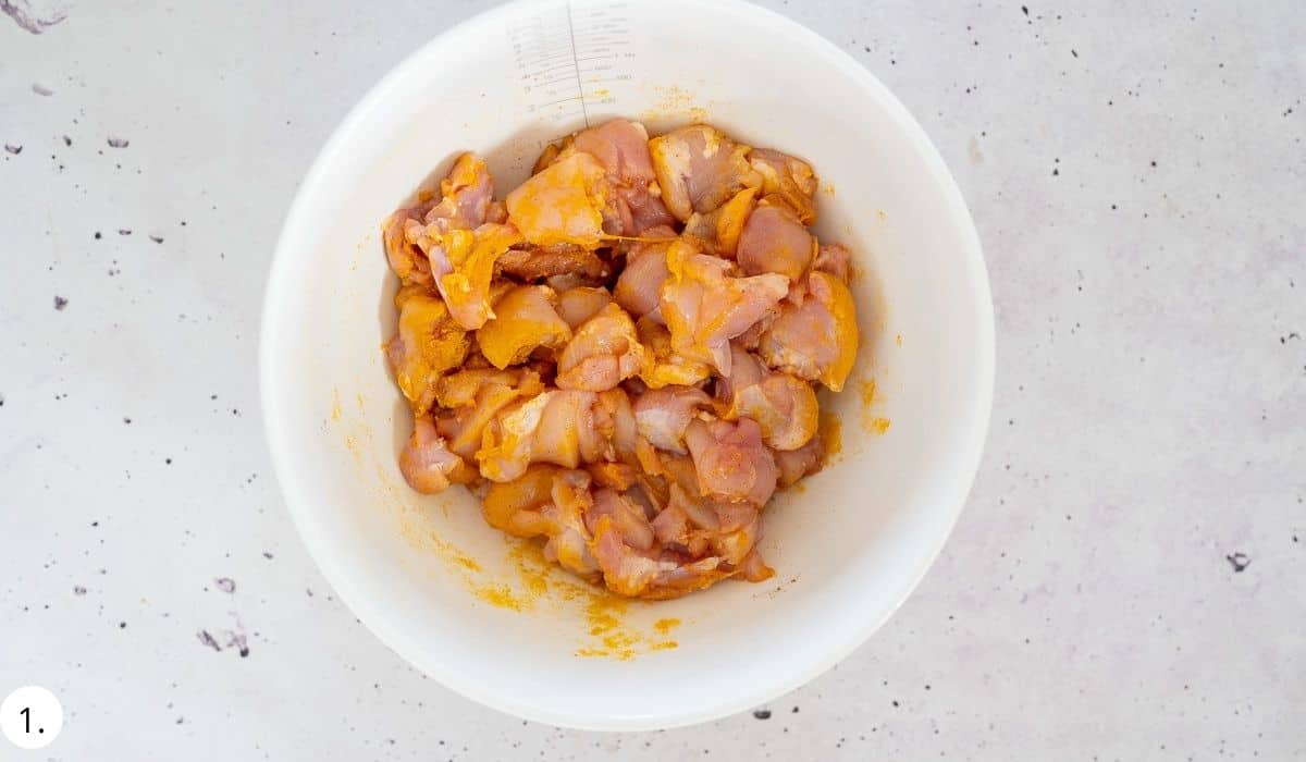 chicken marinating in a bowl