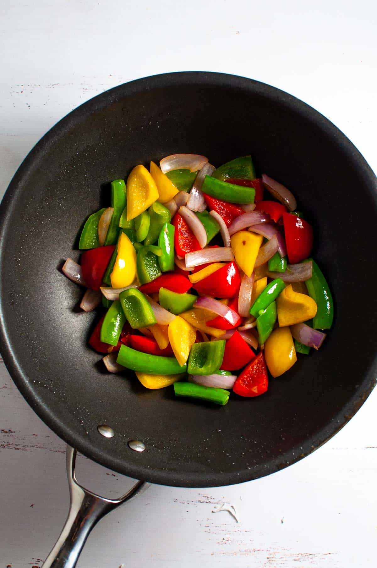 chopped vegetables cooking in a wok