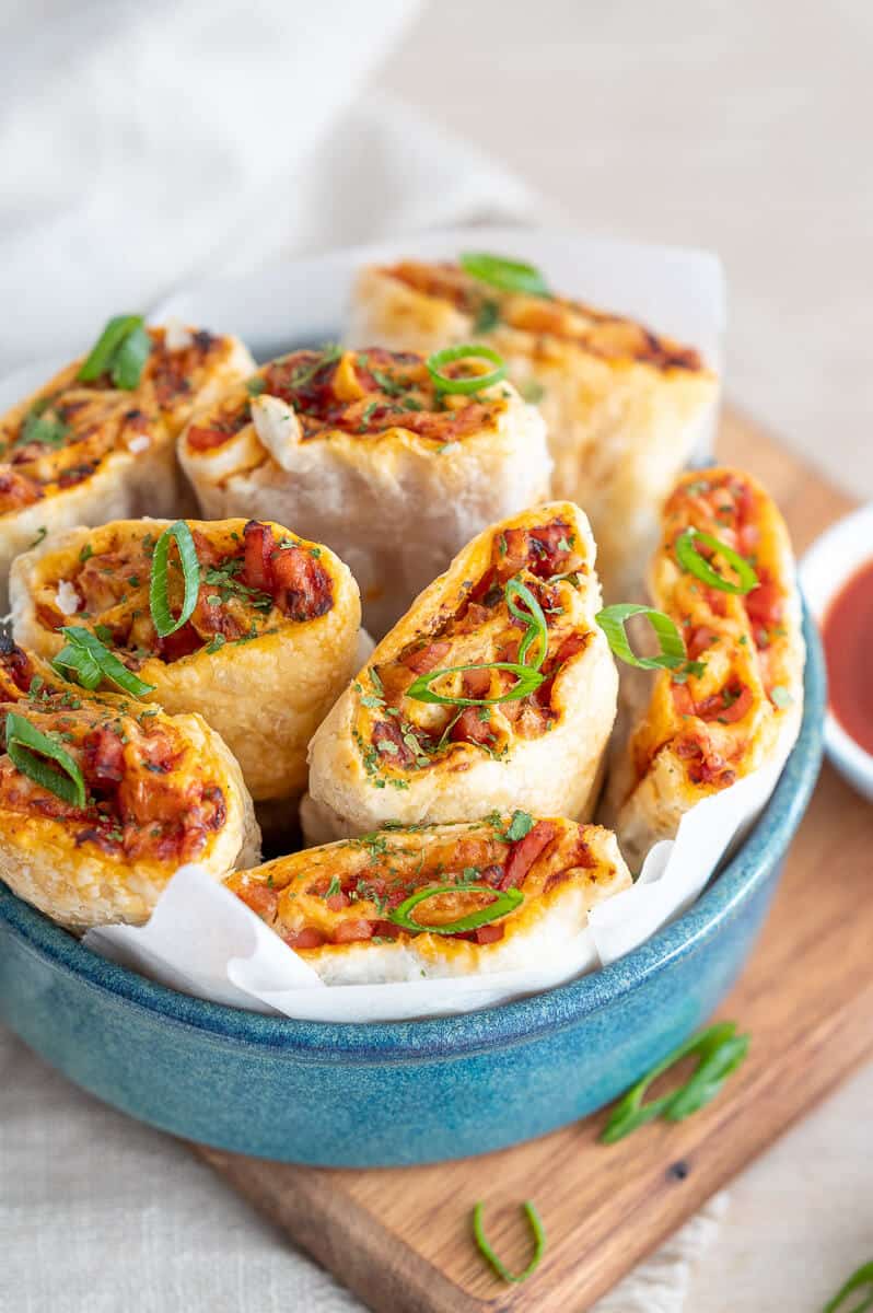 8 air fryer pizza rolls piled into a bowl 