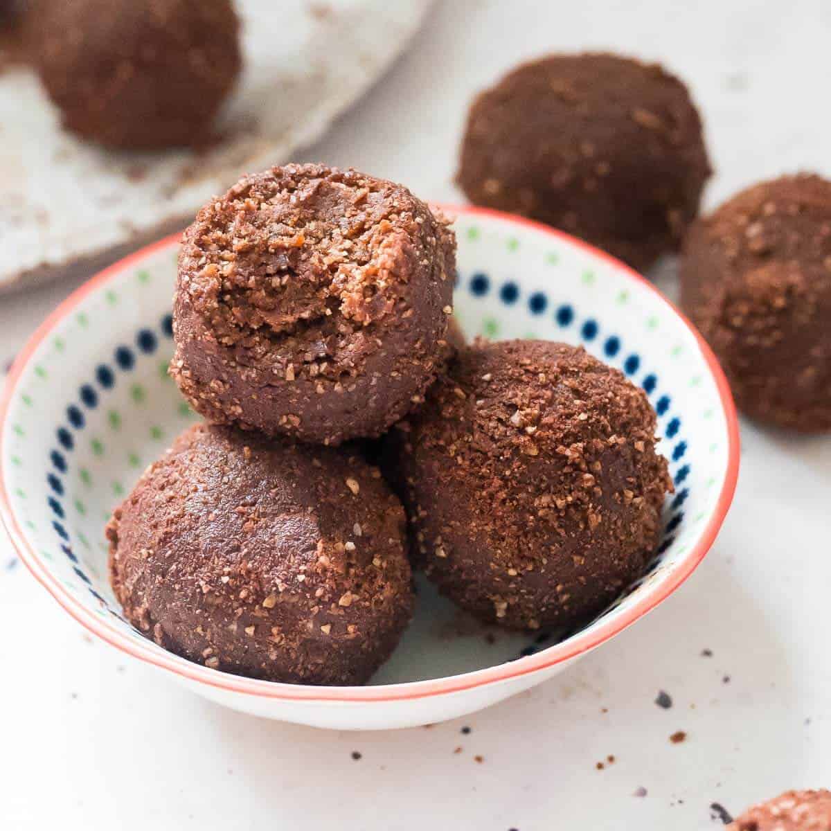 3 chocolate date balls in a bowl