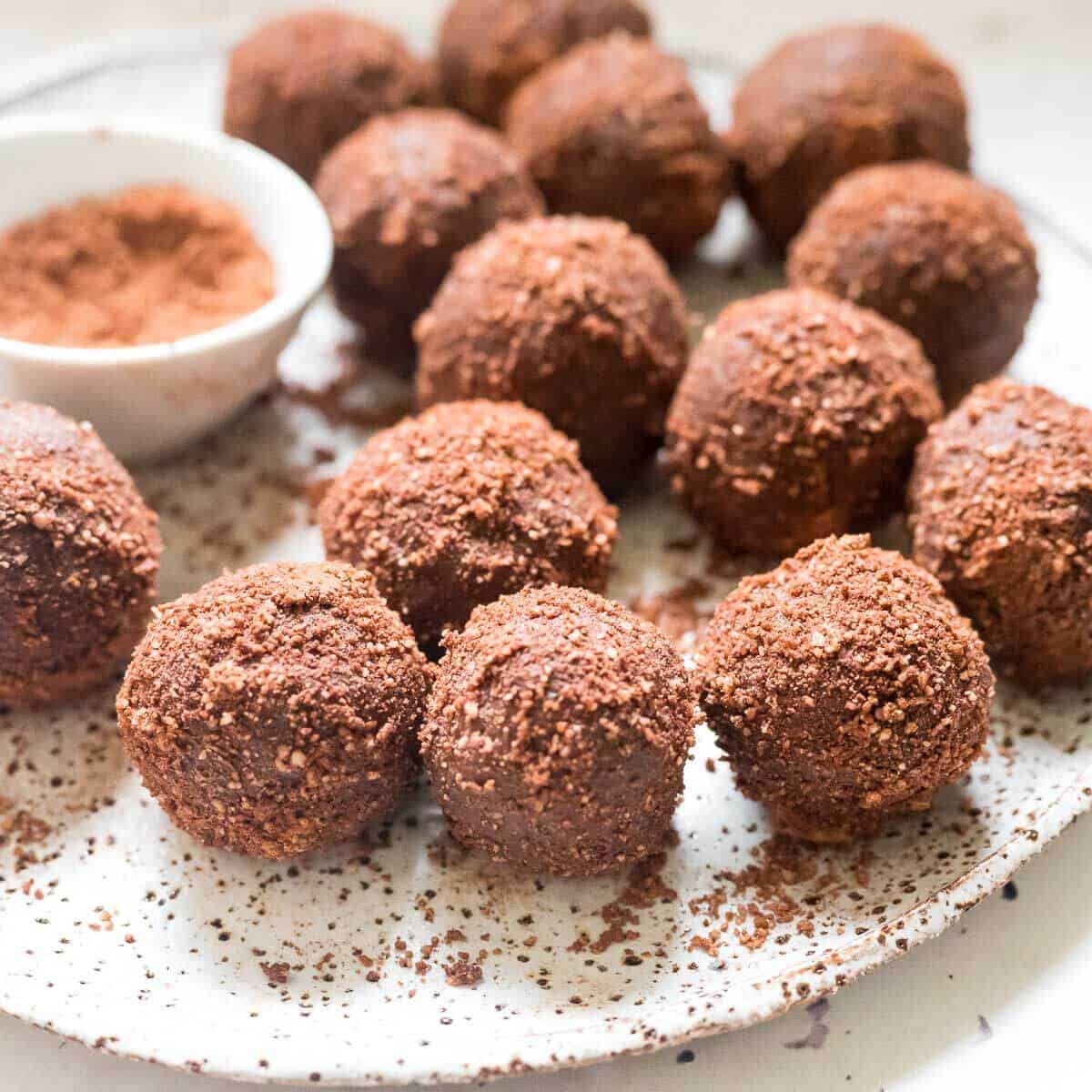 a plate of chocolate almond date balls