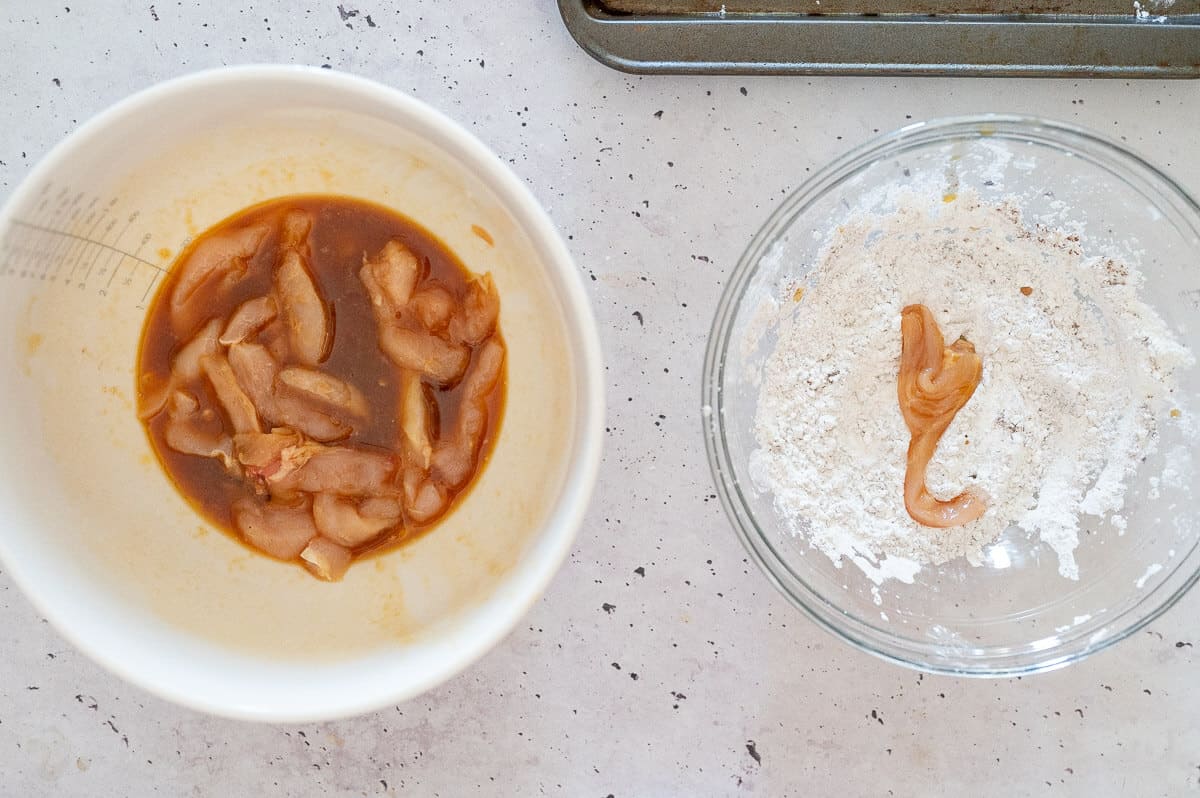 dipping chicken into flour