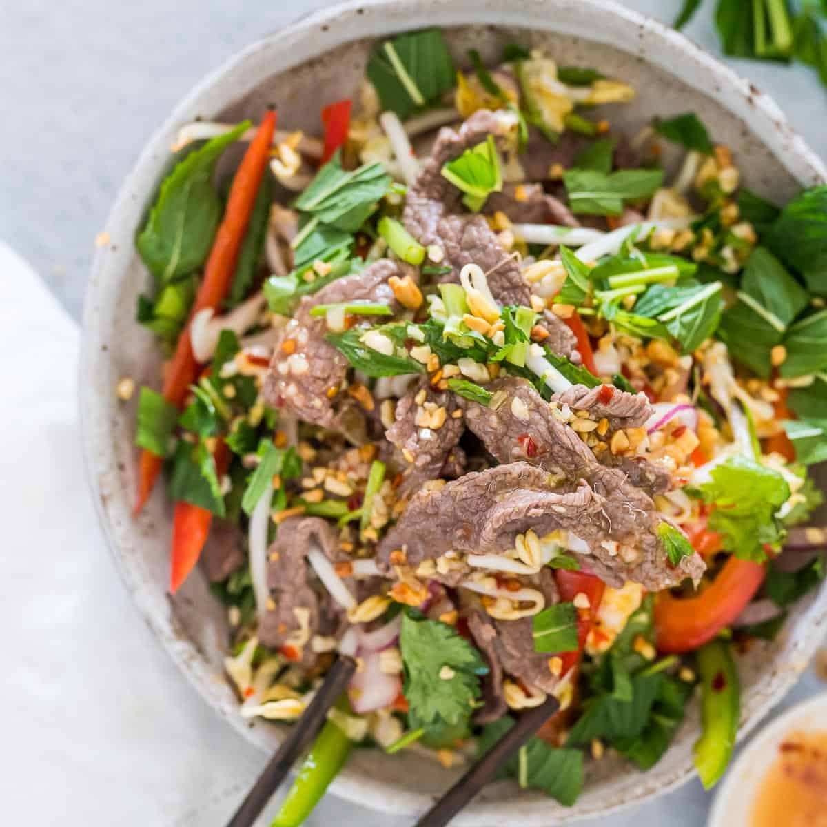 Vietnamese Beef Salad in a bowl with chopsticks