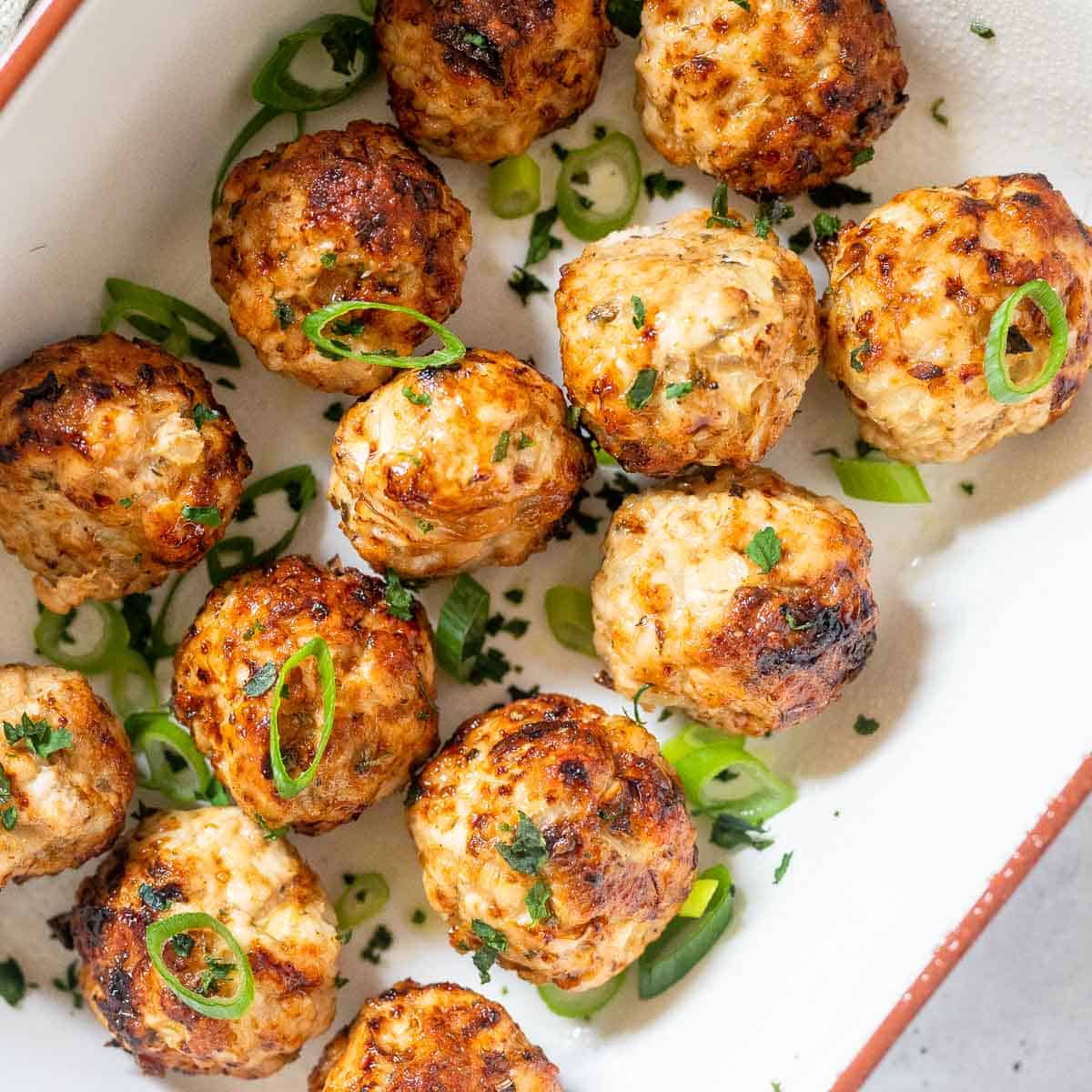 13 cooked turkey meatballs in a dish