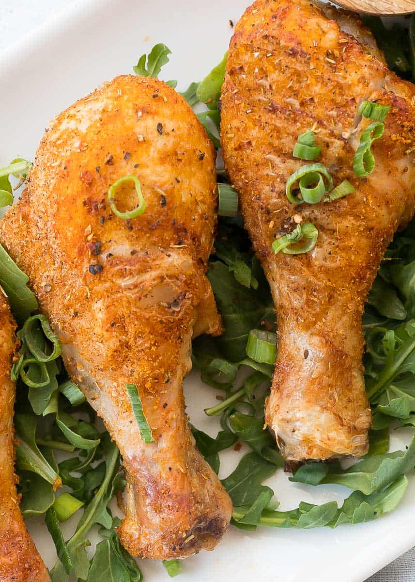 two cooked chicken drumsticks on a plate