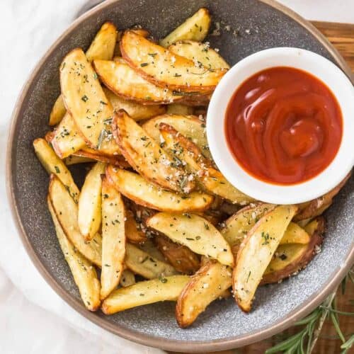 air fyer potato edges in a bowl with ketchup