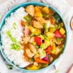 a blue bowl of sweet and sour chicken and rice