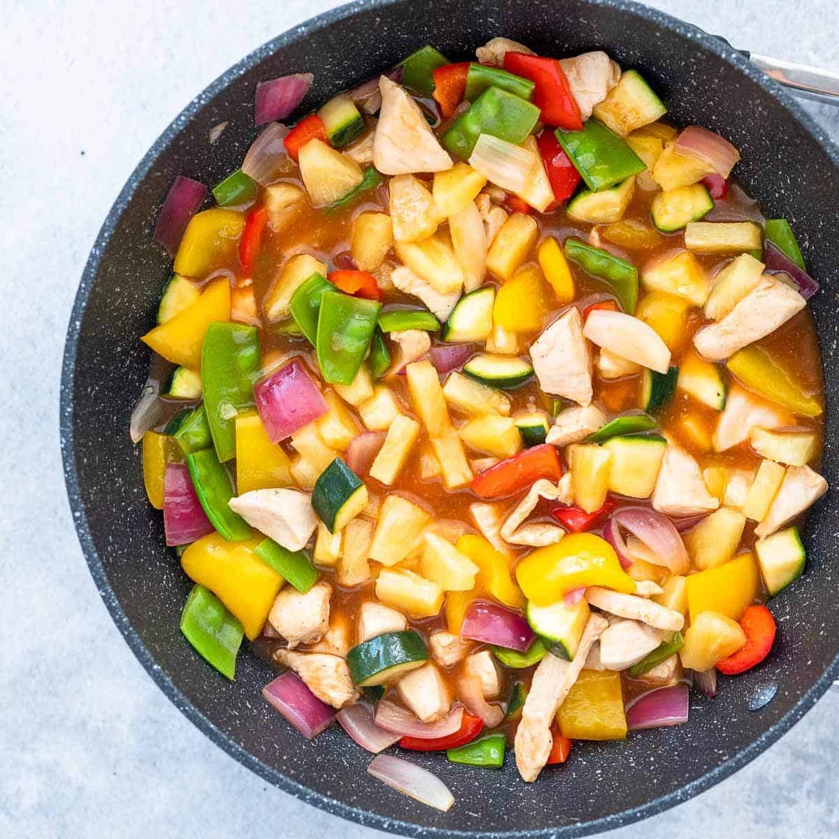 sweet and sour chicken in a wok