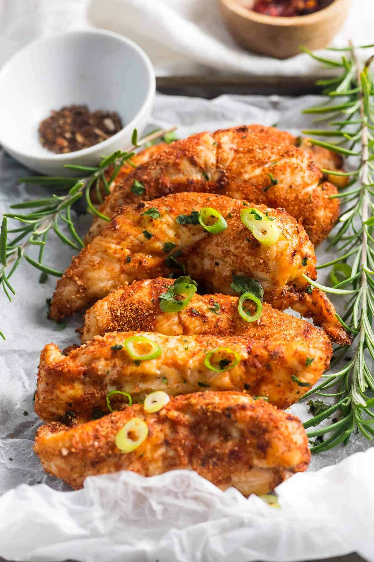 cooked chicken tenders on a serving platter with ranch sauce