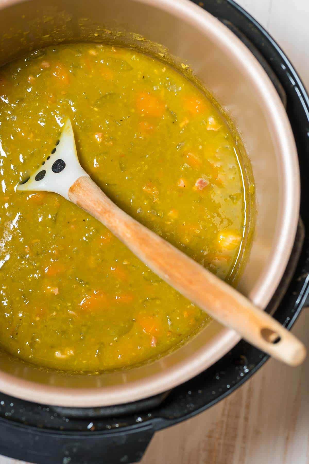 cooked split soup in pressure cooker with spoon