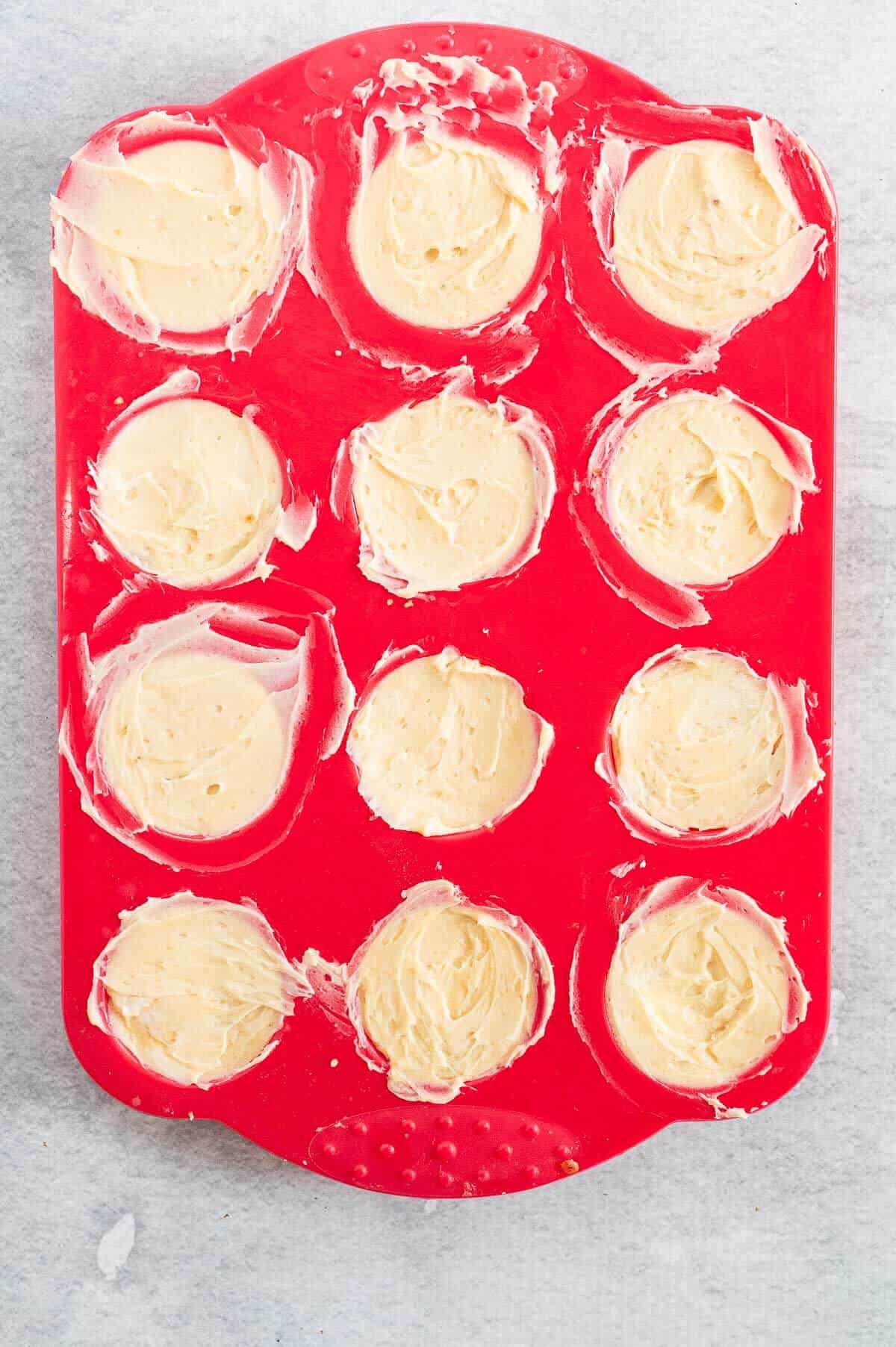 12 hole silicone muffin tray filled with cheesecakes